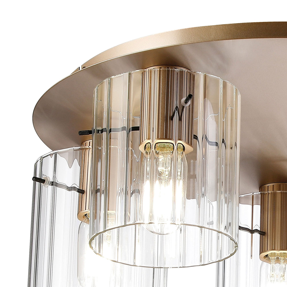 A close-up of a modern brass ceiling light with a fluted glass shade.