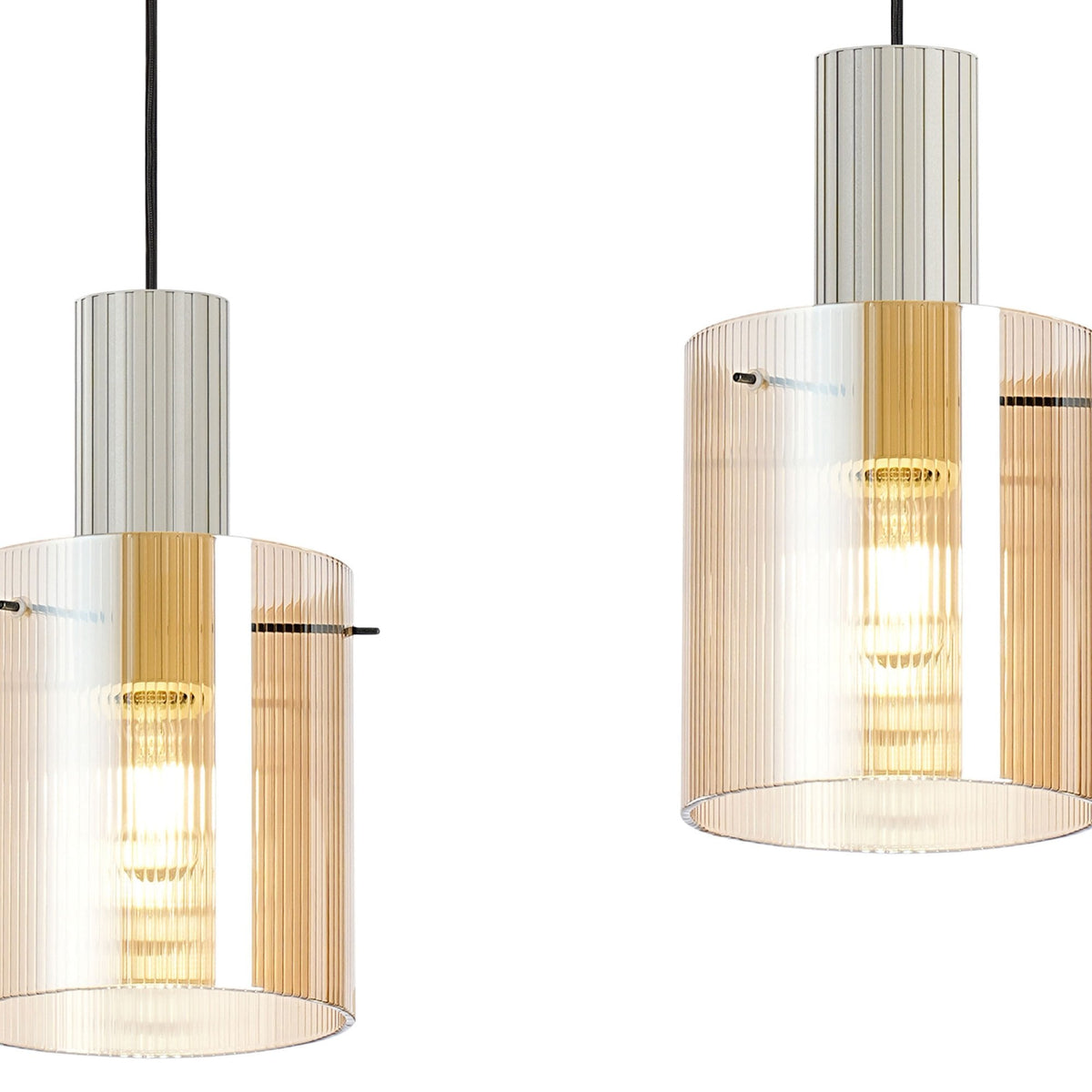 Two close-up cylindrical pendant lights with amber ribbed glass shades.
