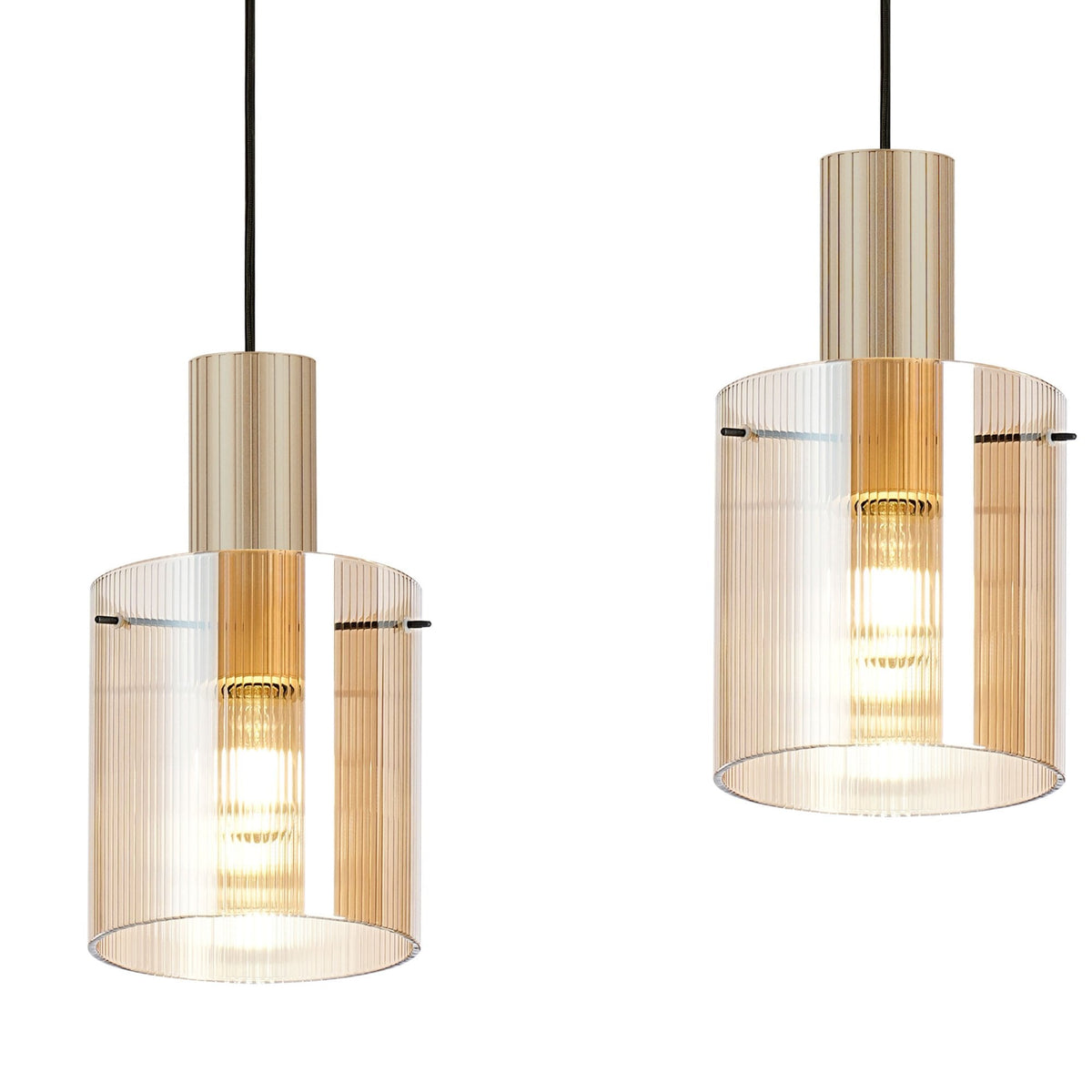 Close-up of two individual pendant lights with ribbed amber glass and gold-coloured bases.