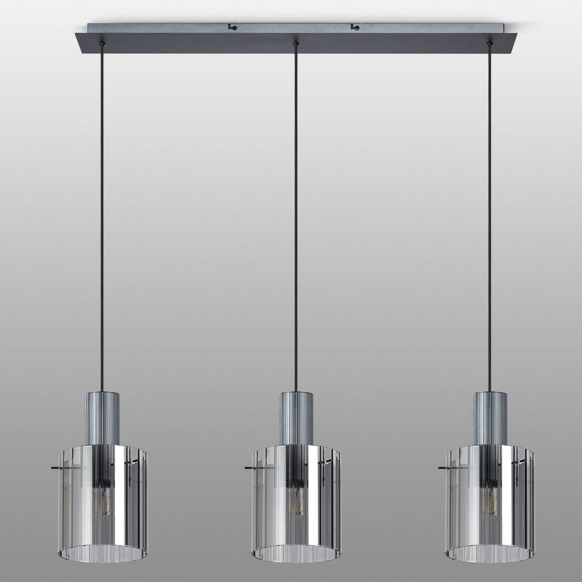 A trio of elegant pendant lights featuring clear ribbed glass and metallic accents.