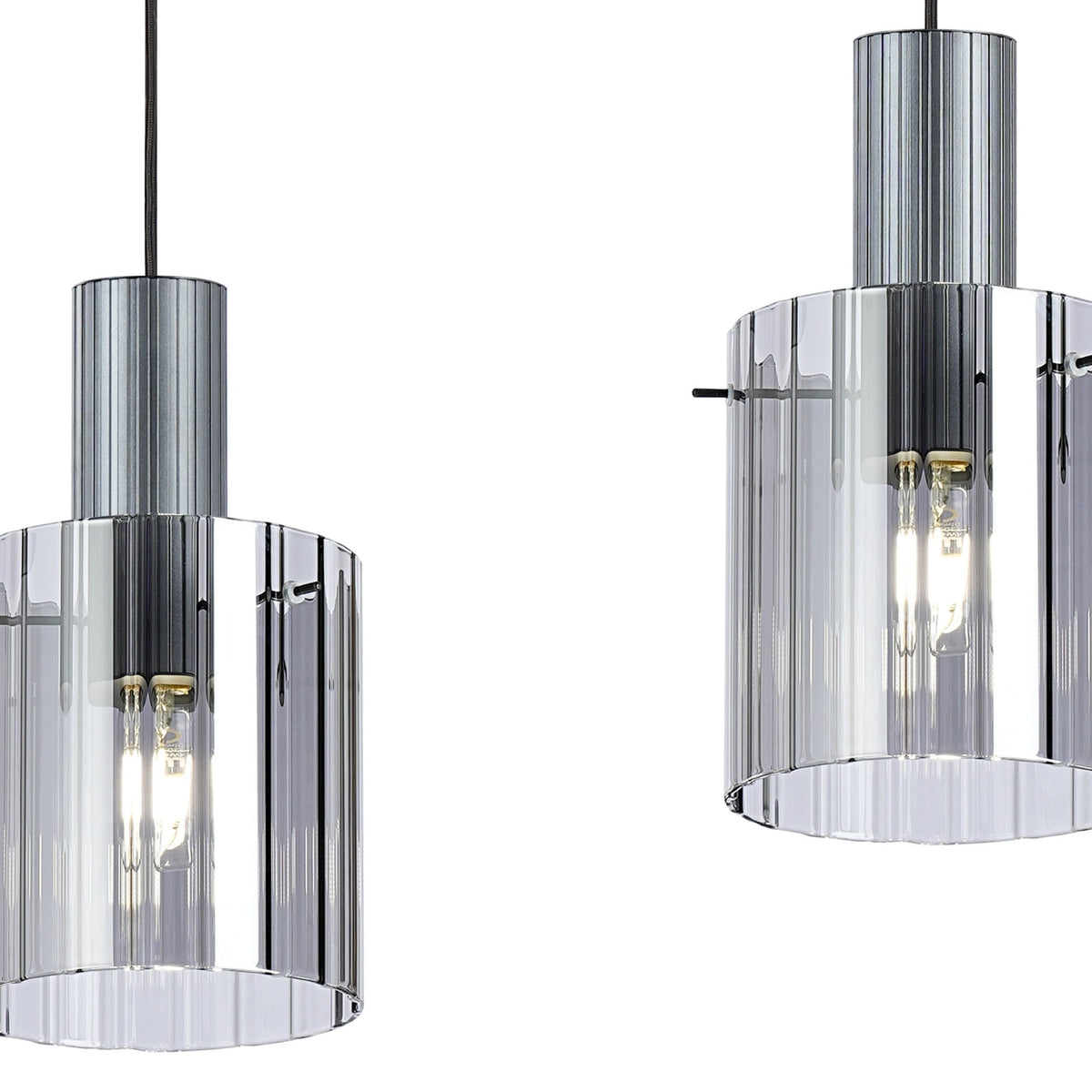 Close-up of two ribbed glass pendant light shades with metallic tops.