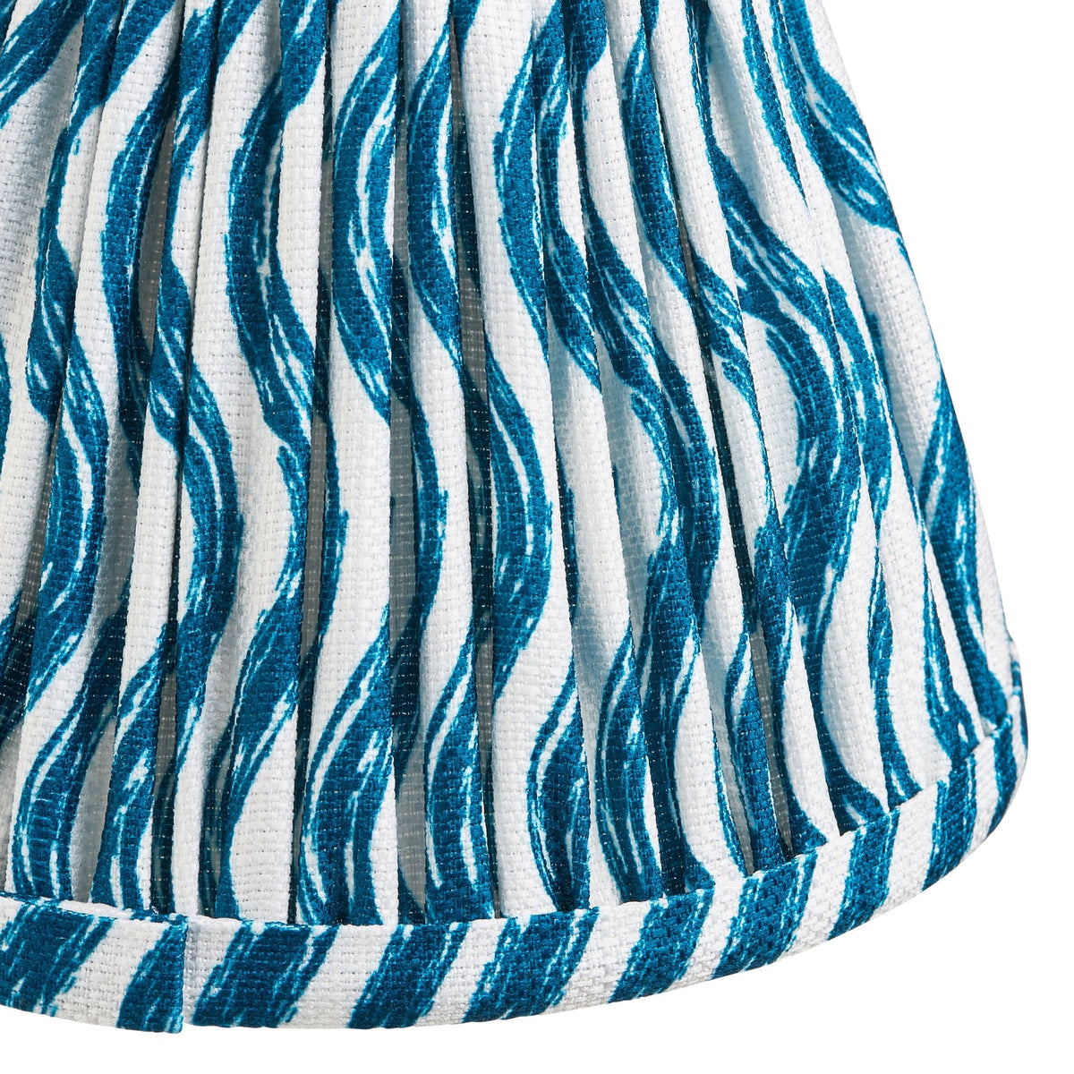 Close-up of a blue and white patterned pleated lamp shade.