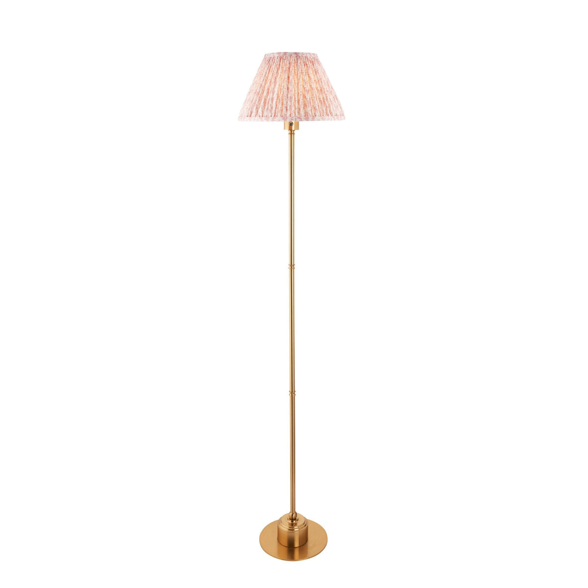A brass floor lamp with a pleated, patterned lampshade on a white background.