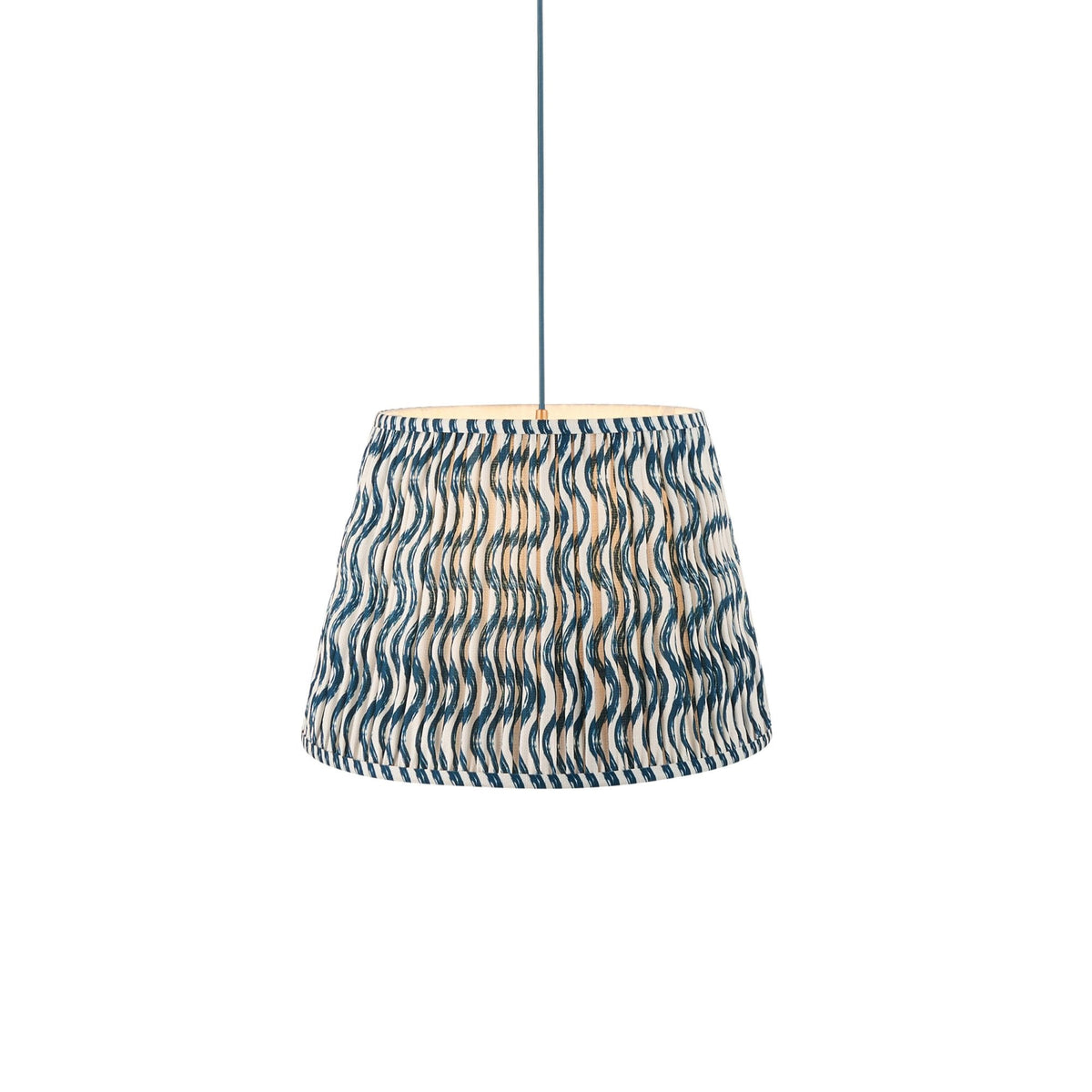 A pleated blue and white wavy patterned lampshade on a white background.