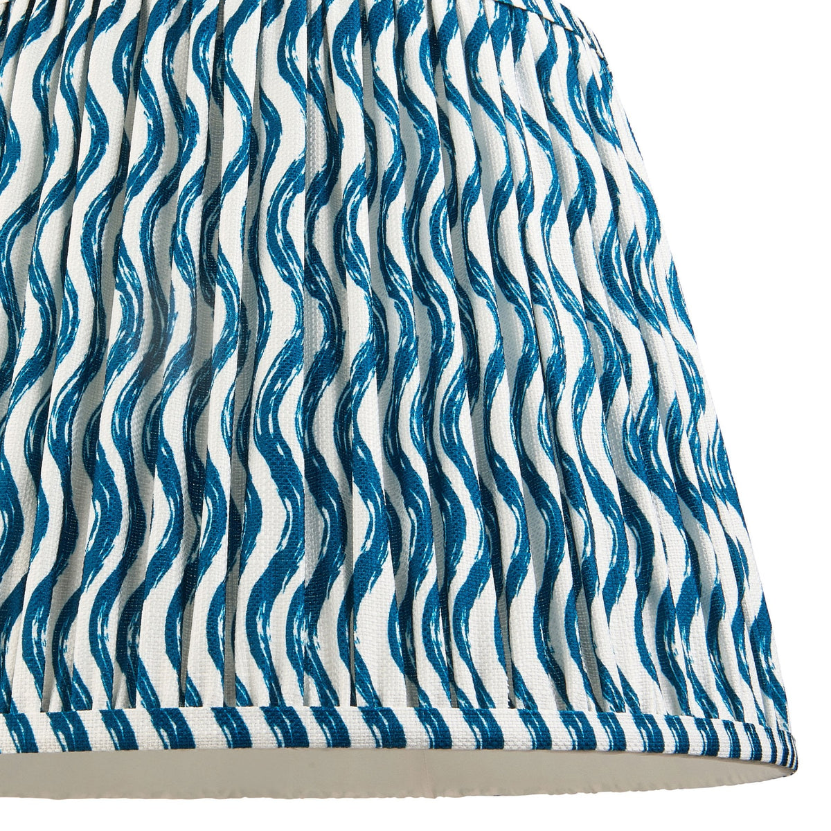 A close-up of the pleated blue and white wavy patterned lampshade.
