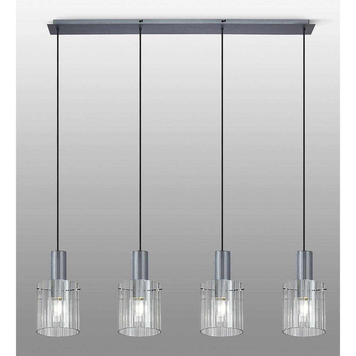 Four hanging lights with ribbed glass shades, viewed from a straight angle on a grey background.