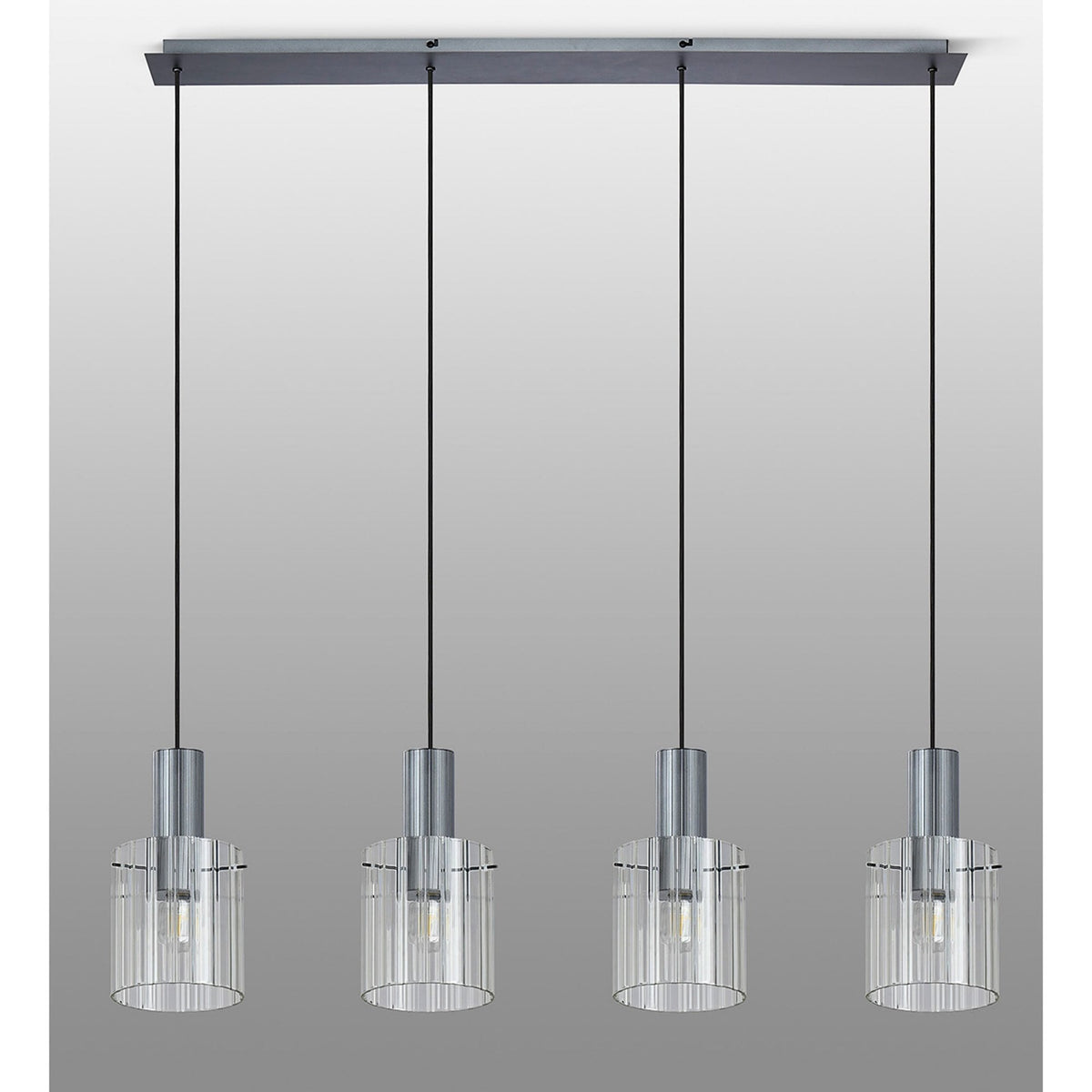 Four hanging lights with ribbed glass shades, viewed from a straight angle on a grey background.