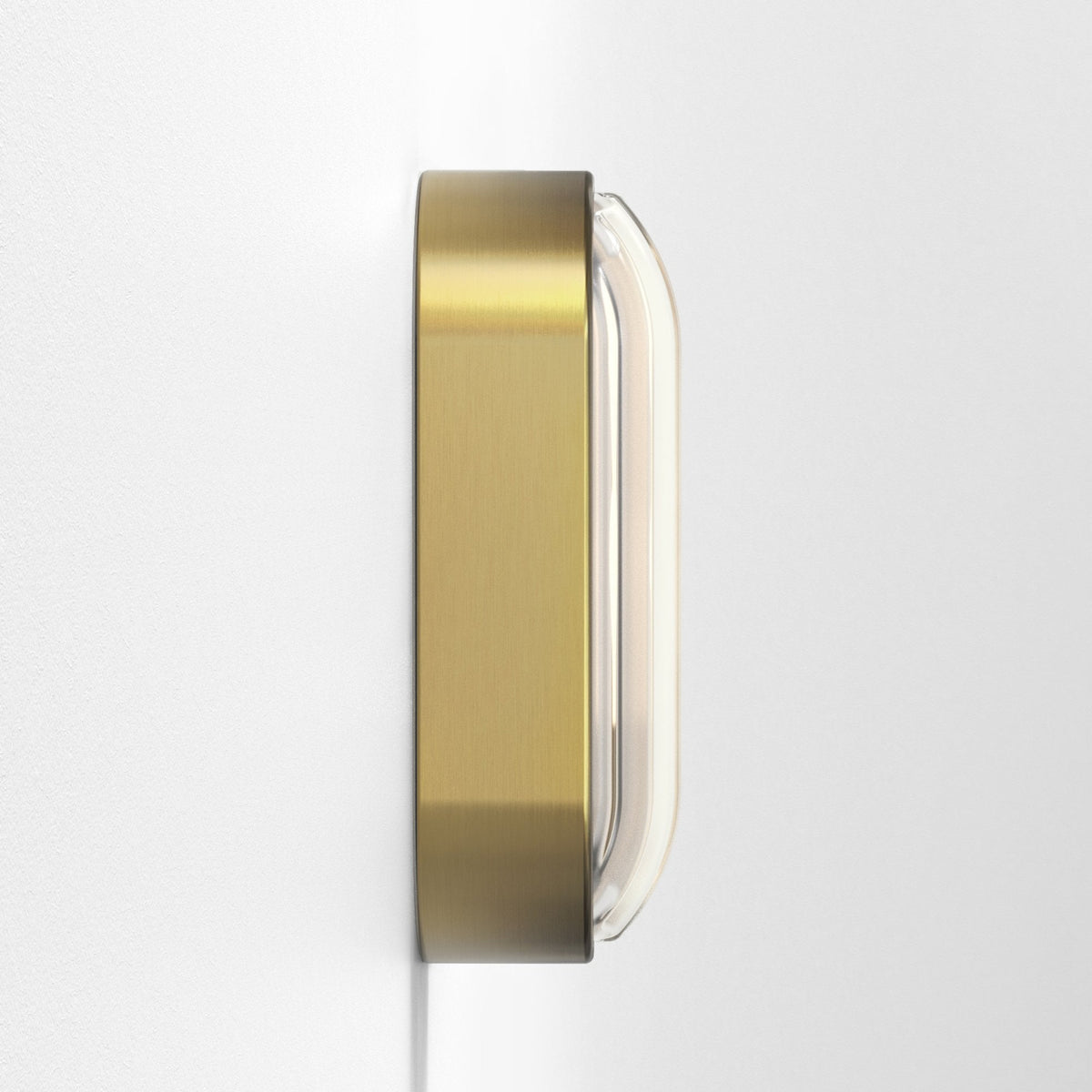 Side view of a rectangular brass wall light with a clear glass diffuser