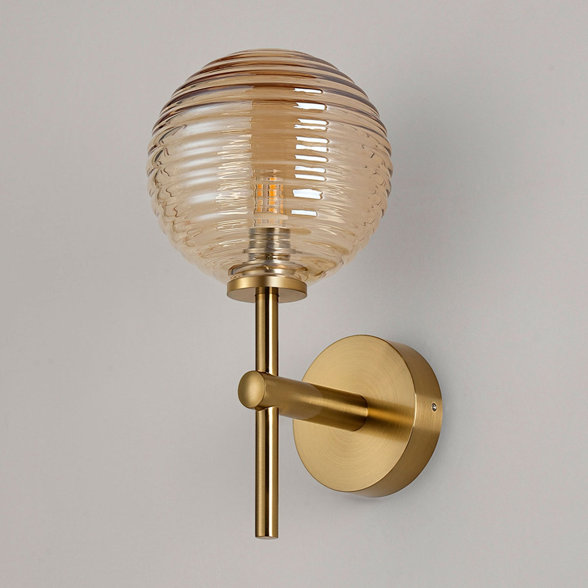 Tenterden Medium Arm IP44 Wall Light in Brass Gold with Ribbed Round Amber Glass Diffuser