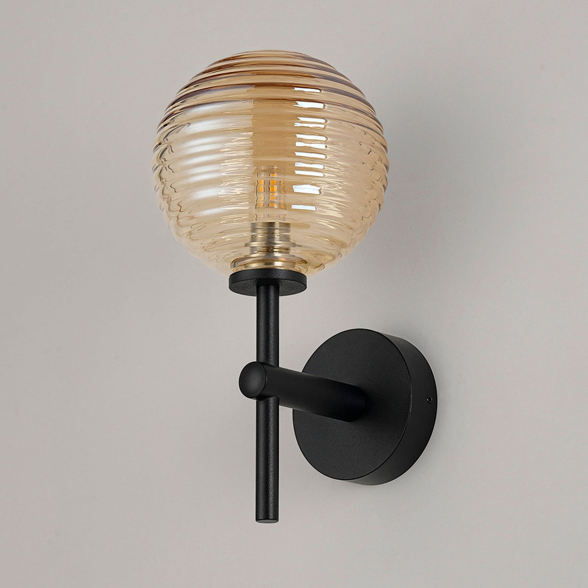 Tenterden Medium Arm IP44 Wall Light in Satin Black with Ribbed Round Amber Glass Diffuser