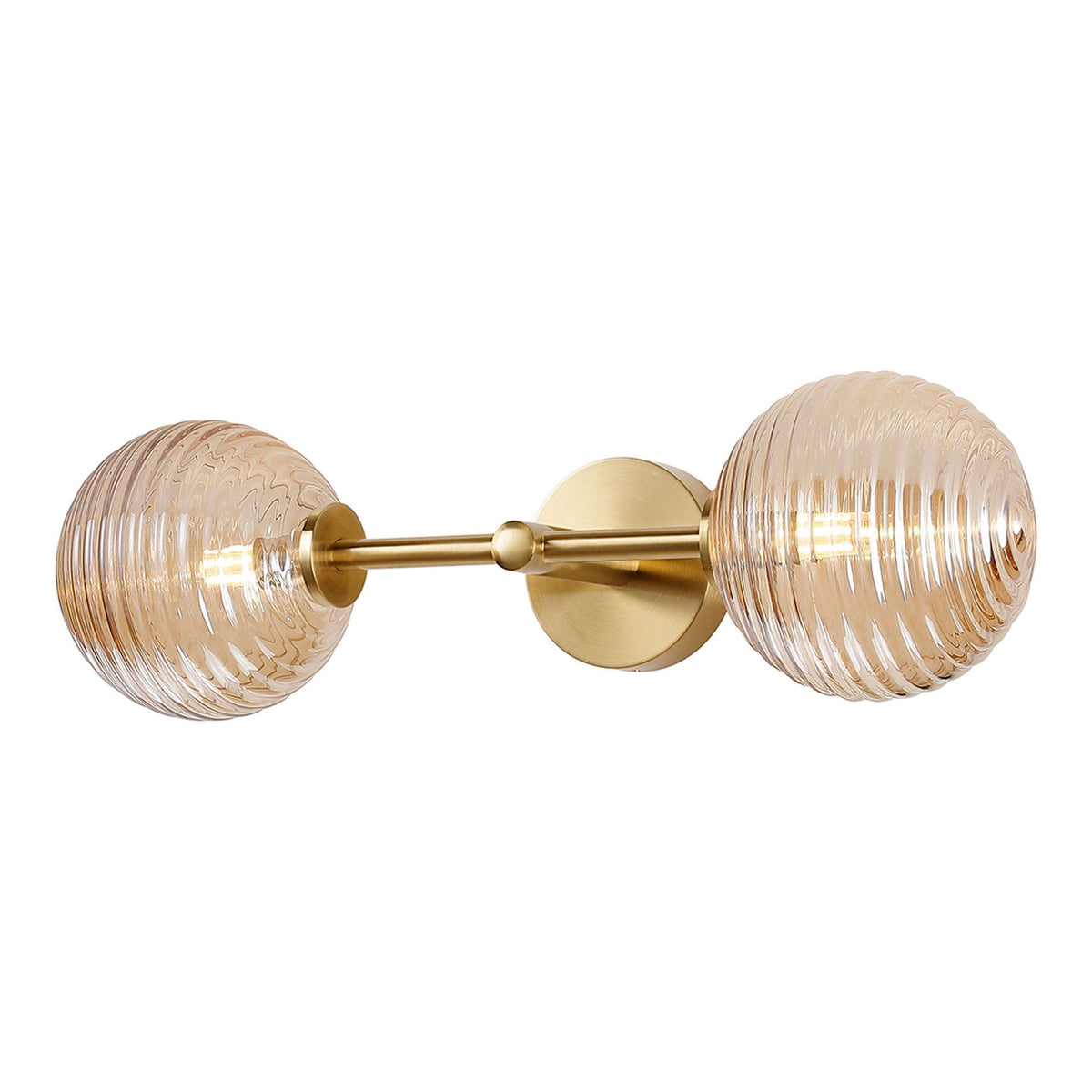 A horizontal brass wall light featuring two amber ribbed glass globes, illuminating.