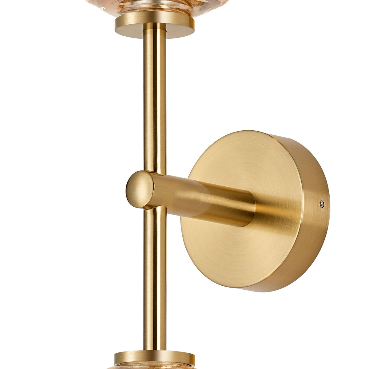 Close-up of the brass fixture of a wall light, showcasing the detailed craftsmanship.