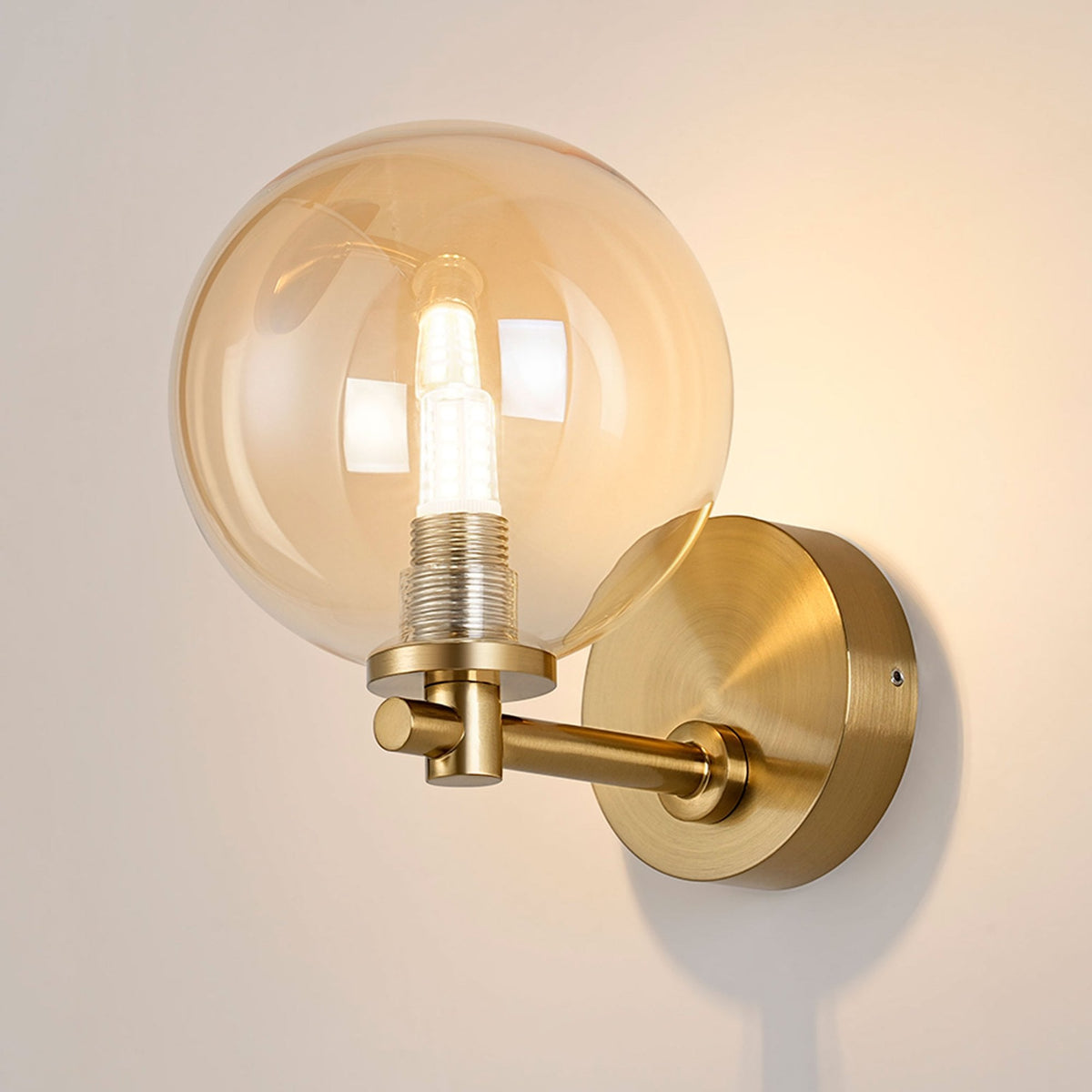 Tenterden Short Arm IP44 Wall Light in Brass Gold with Smooth Round Amber Glass Diffuser