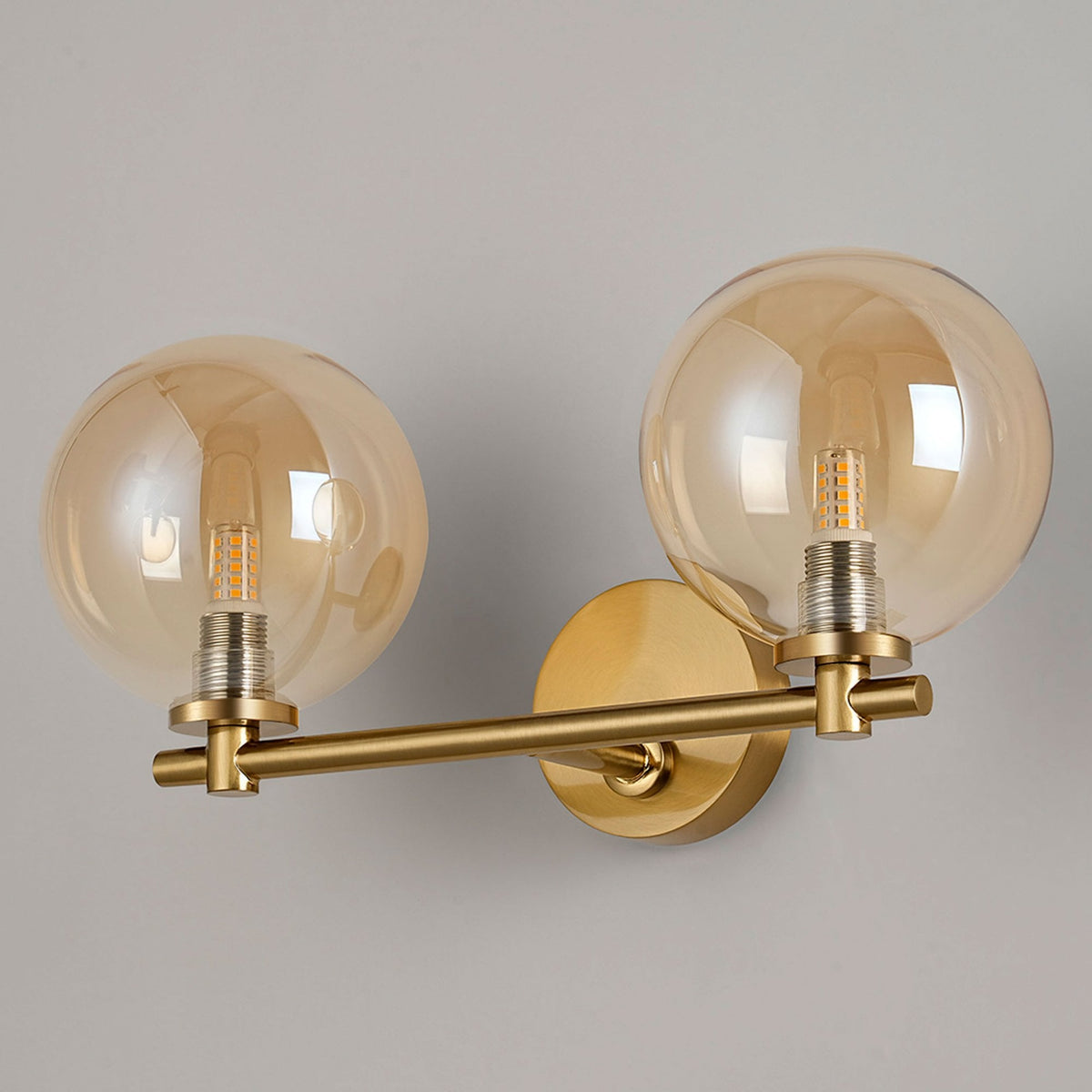 Tenterden Short Twin Arm IP44 Wall Light in Brass Gold with Smooth Round Amber Glass Diffusers