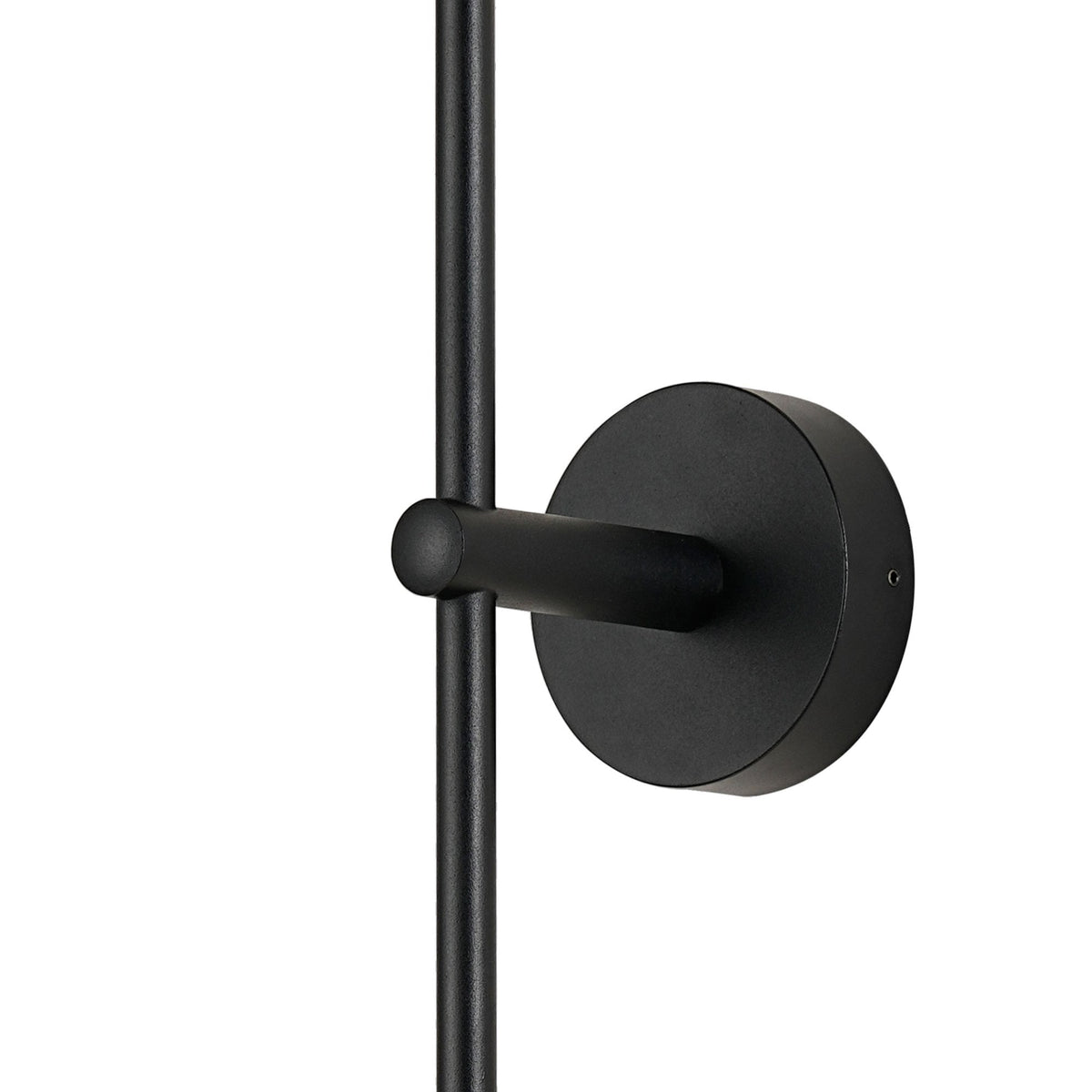 Close-up of the black mounting bracket and stem of the wall light.