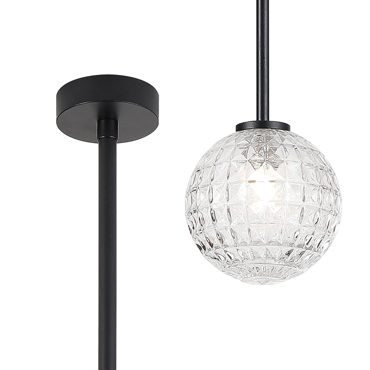 Close-up of a black pendant light with a textured glass globe.