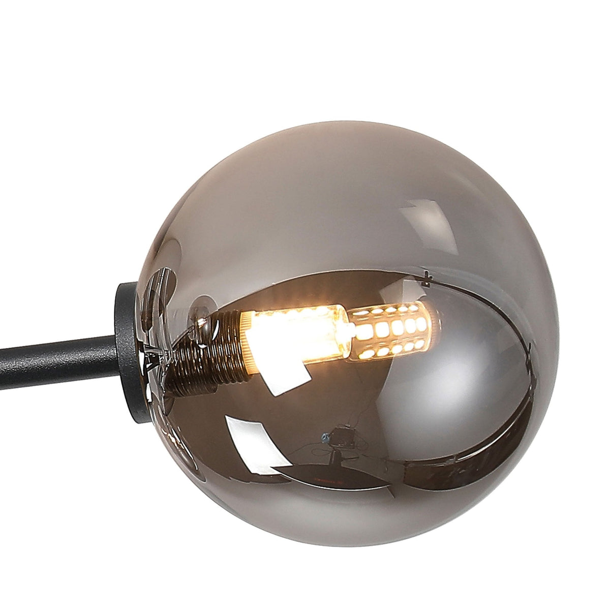 Close-up of a smoked glass sphere shade with an illuminated LED filament bulb inside.