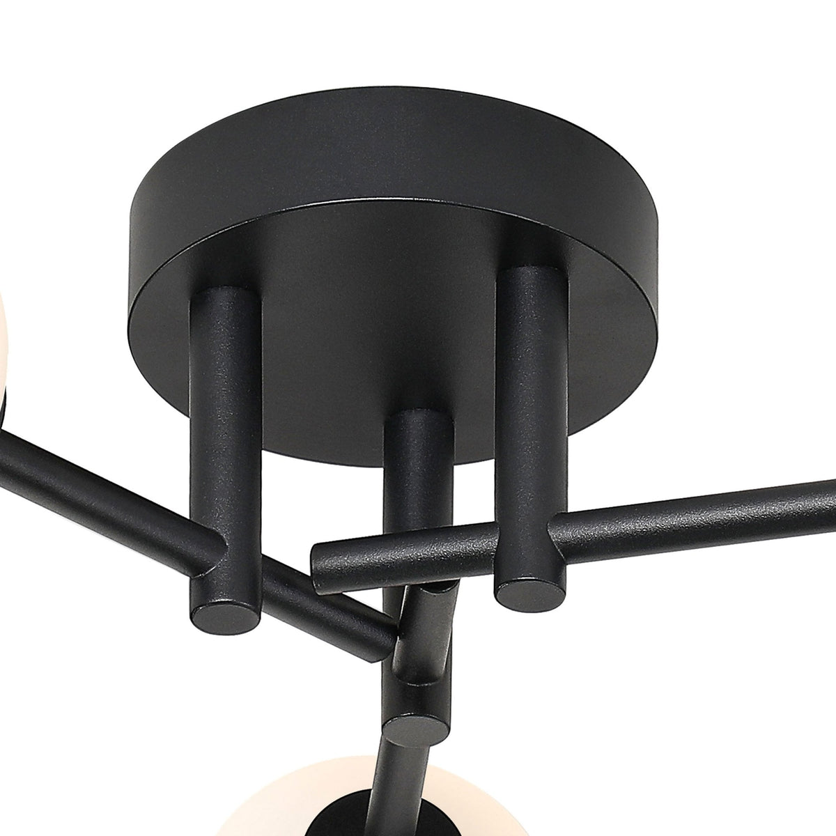A close-up view of the black base and arms of a modern ceiling light.