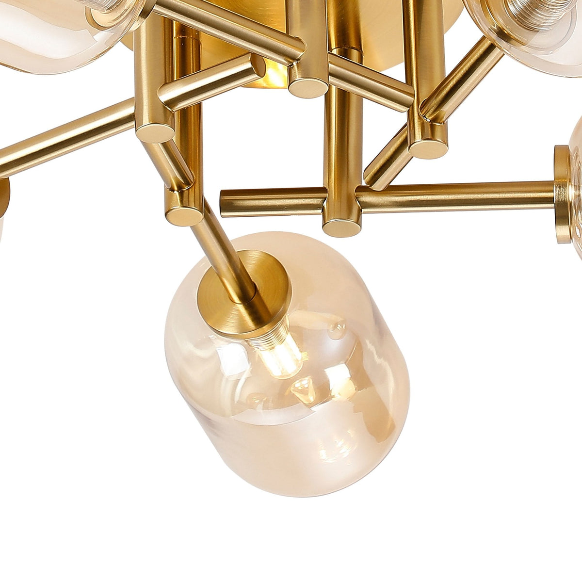 Close-up of the brass fixture and one amber glass shade of a modern ceiling light.