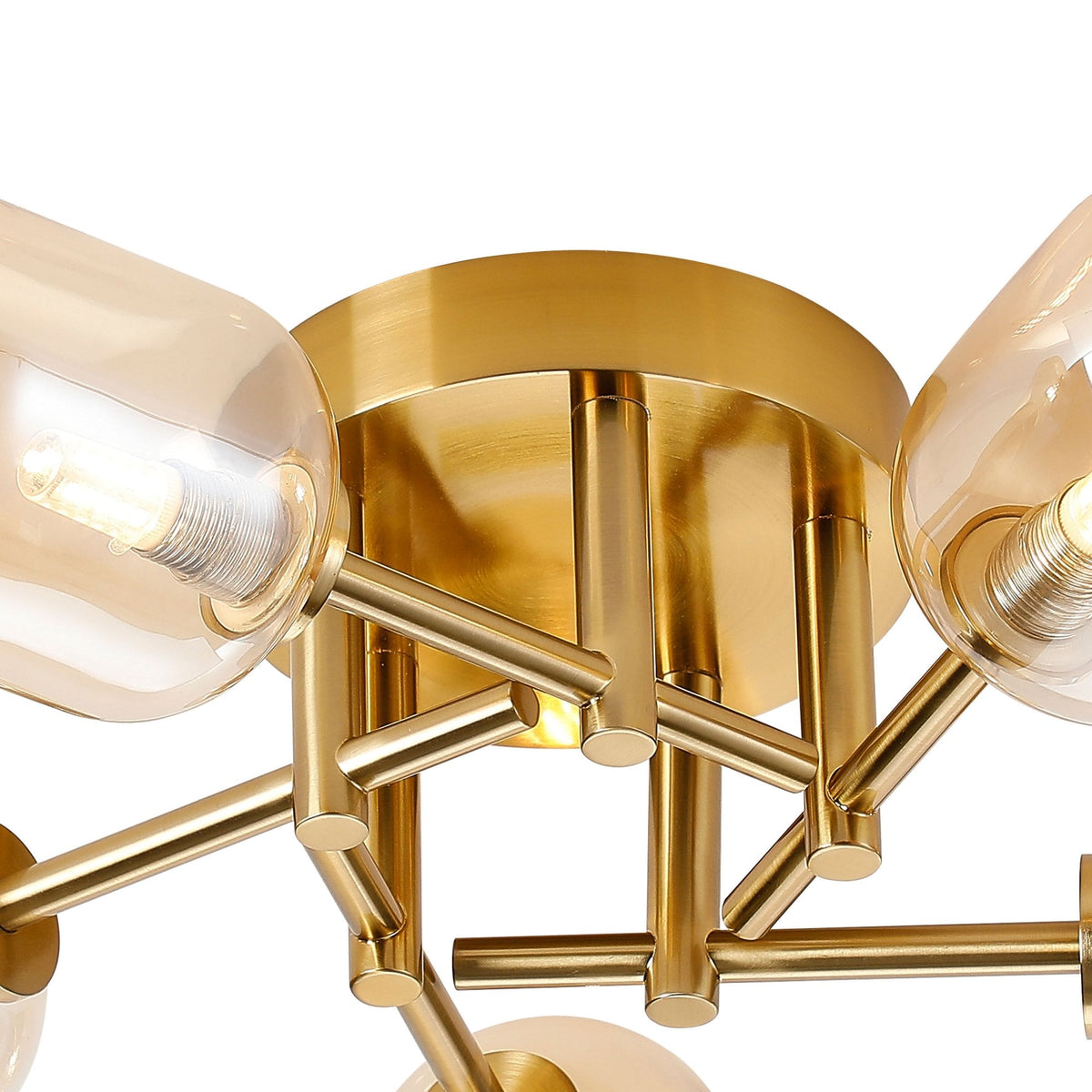 Close-up of the central brass fixture and two amber glass shades of a ceiling light.