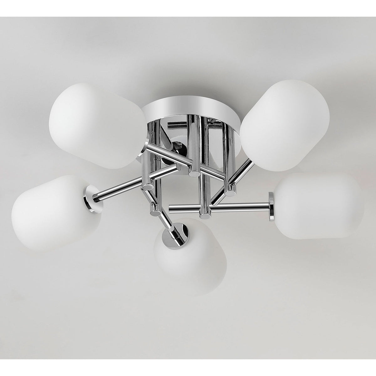 A close up of the chrome and white glass light fixture on a white ceiling.