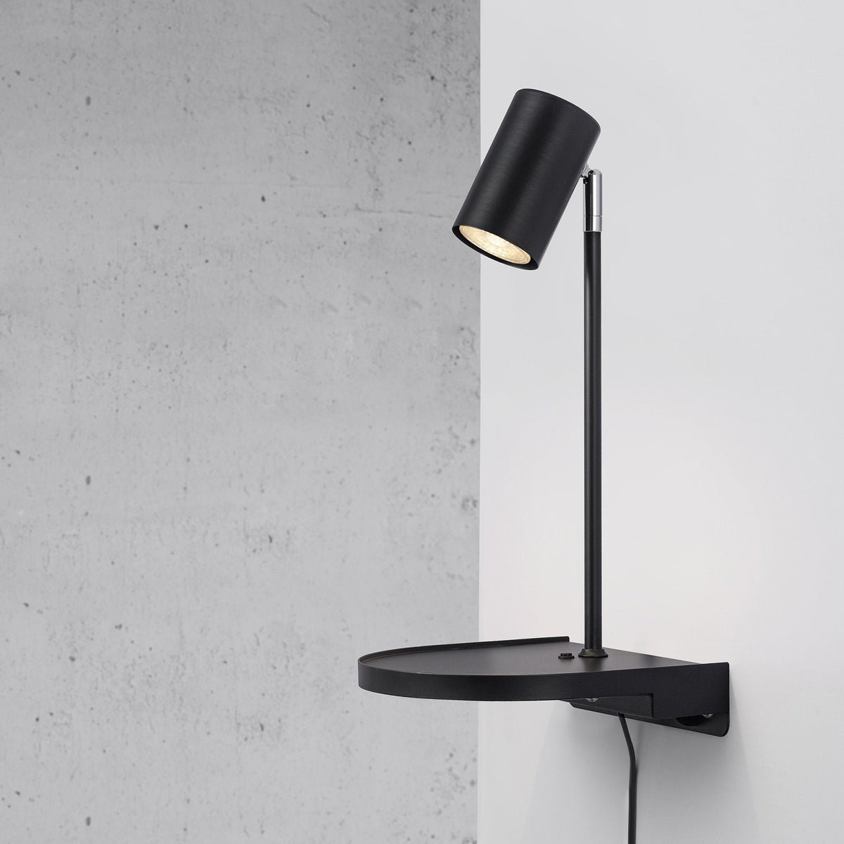 Cody Plugged Adjustable Wall Mounted Lamp In Black With Shelf