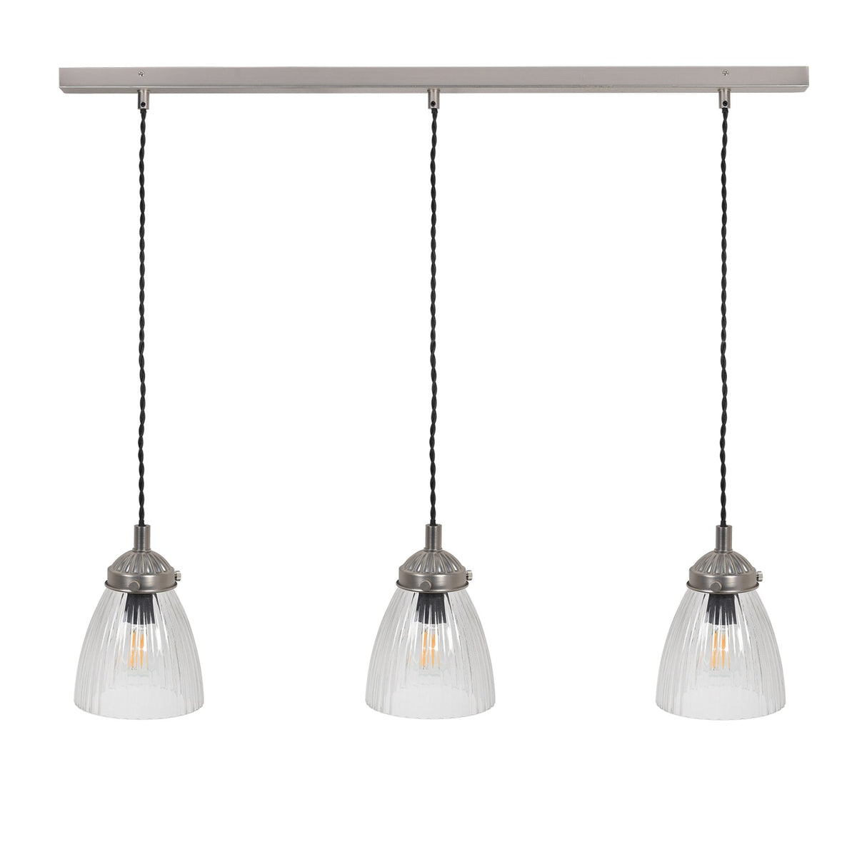 Three clear fluted glass pendant lights with brushed metal fittings hang from a long, rectangular bar.
