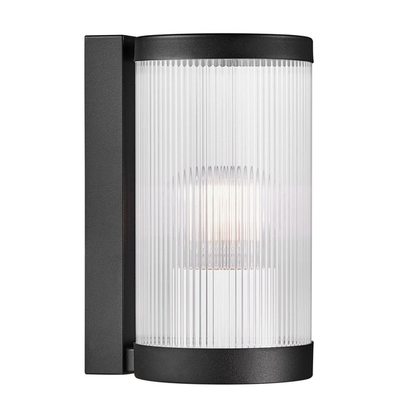 A black cylindrical outdoor wall light with reeded glass, viewed from the front, isolated on white.