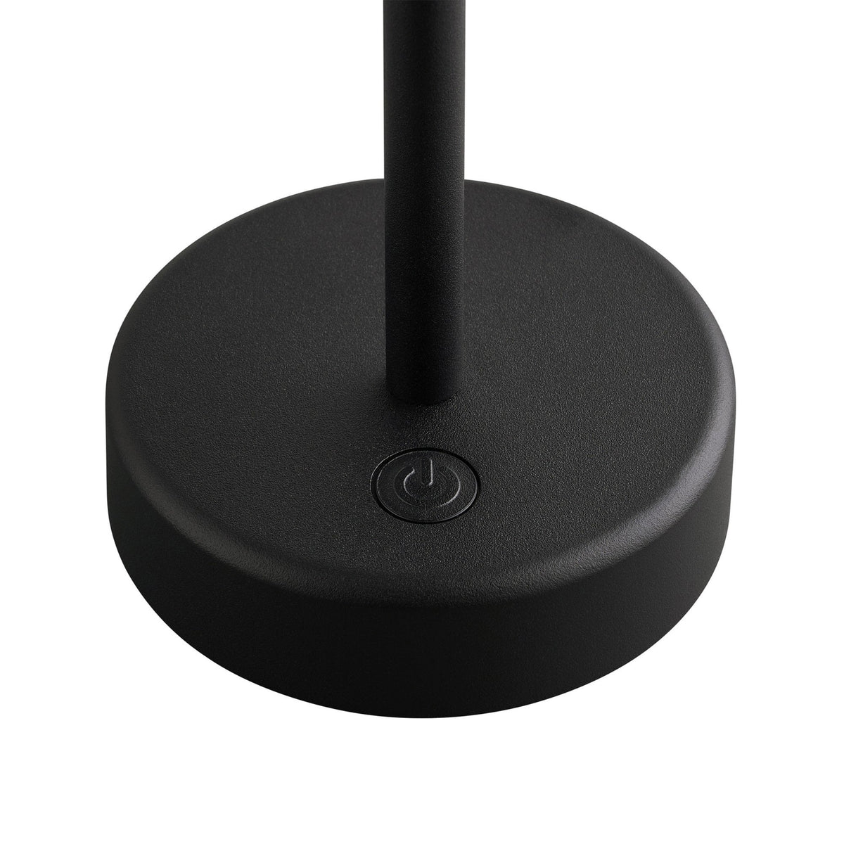 Close-up of the base of a black portable lamp showing the power button.