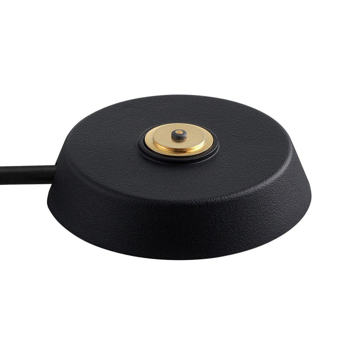Close-up of the charging puck for the black portable lamp, featuring a gold contact.