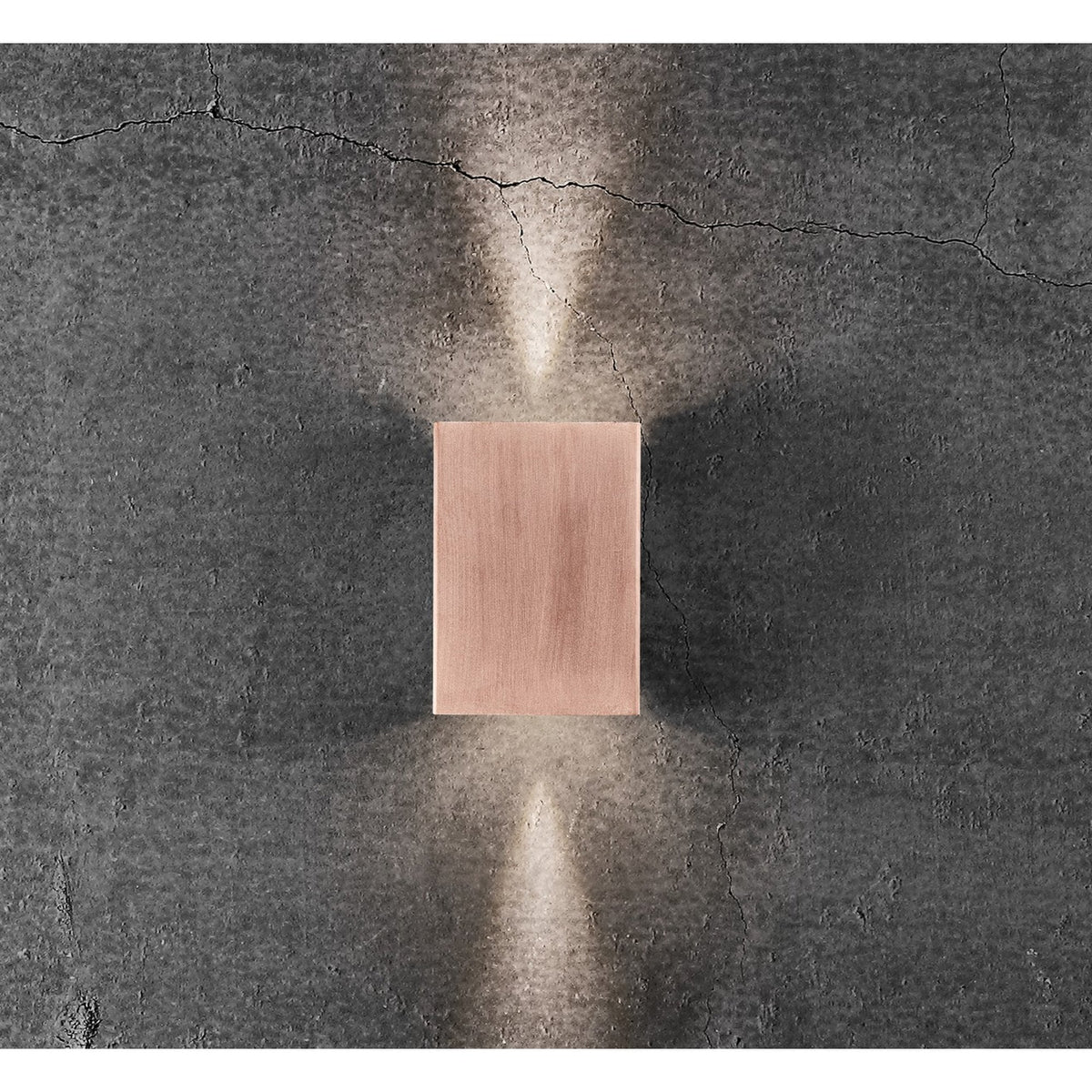 A copper outdoor wall light casts light directly upwards and downwards.