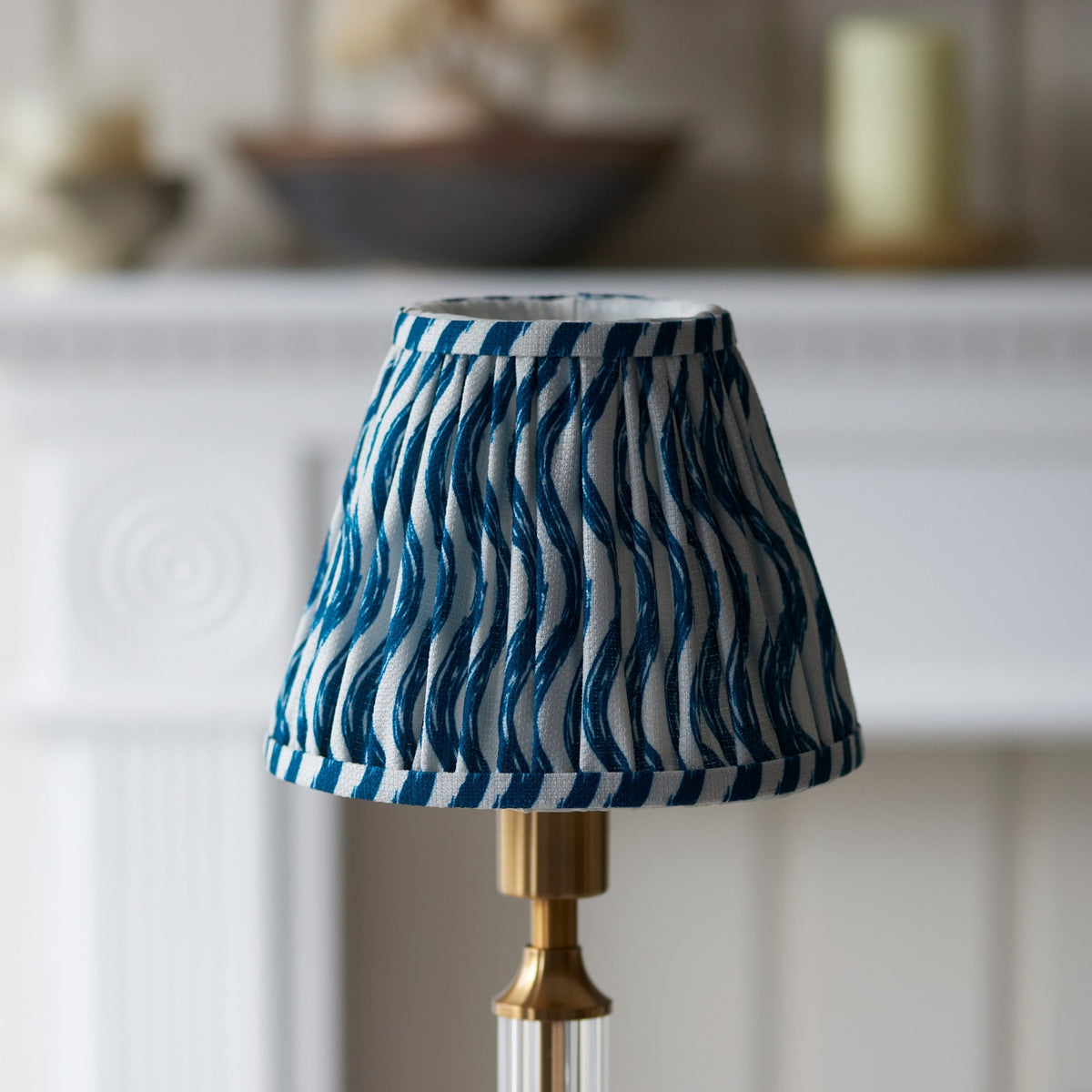 Close-up of the blue and white patterned shade on a table lamp base.