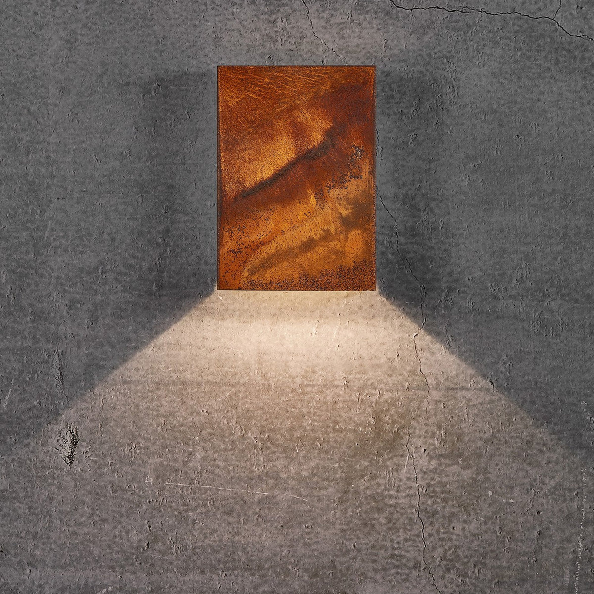 A downward glowing outdoor wall light in a rustic rusted finish.