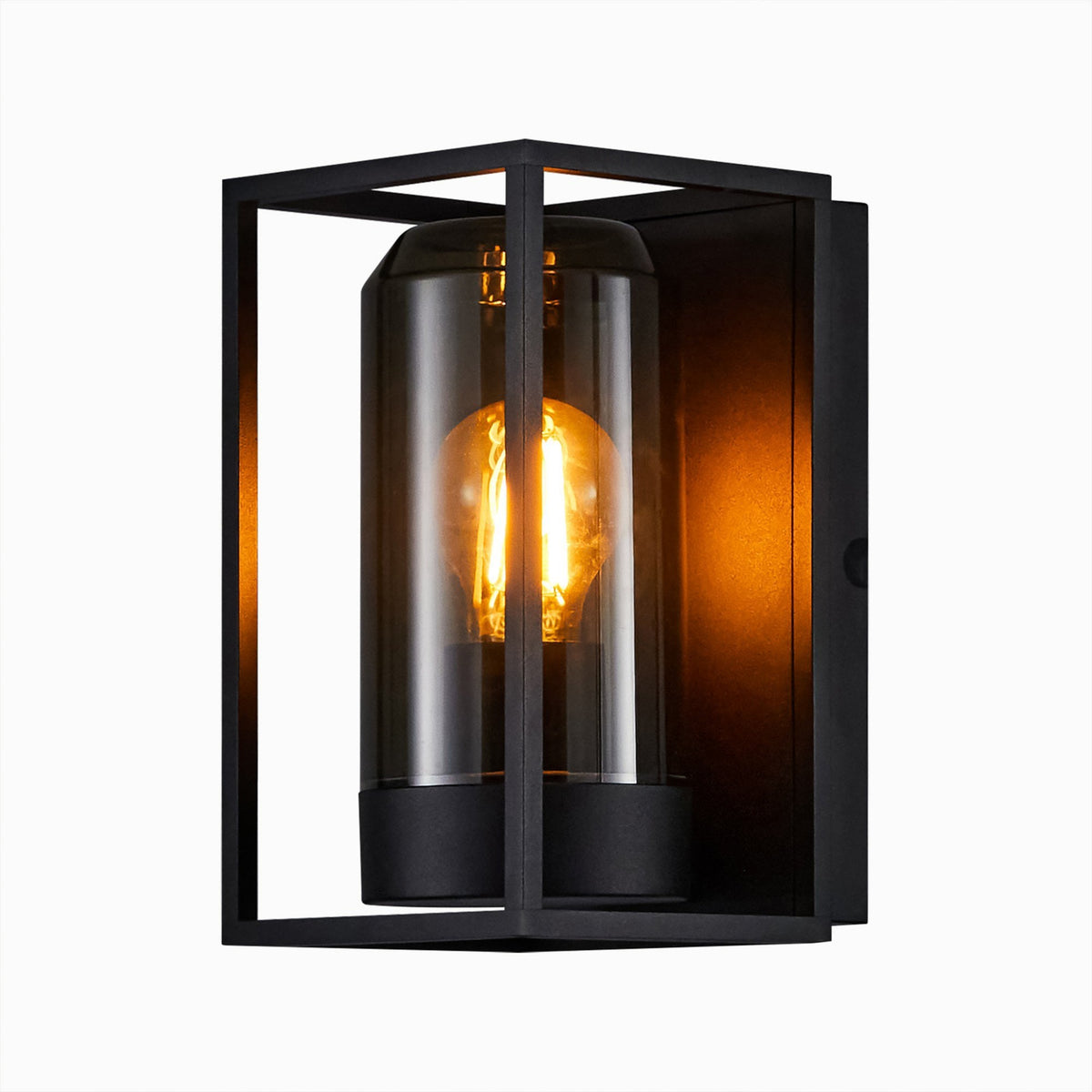 A close-up of a black outdoor wall light with a glowing filament bulb.