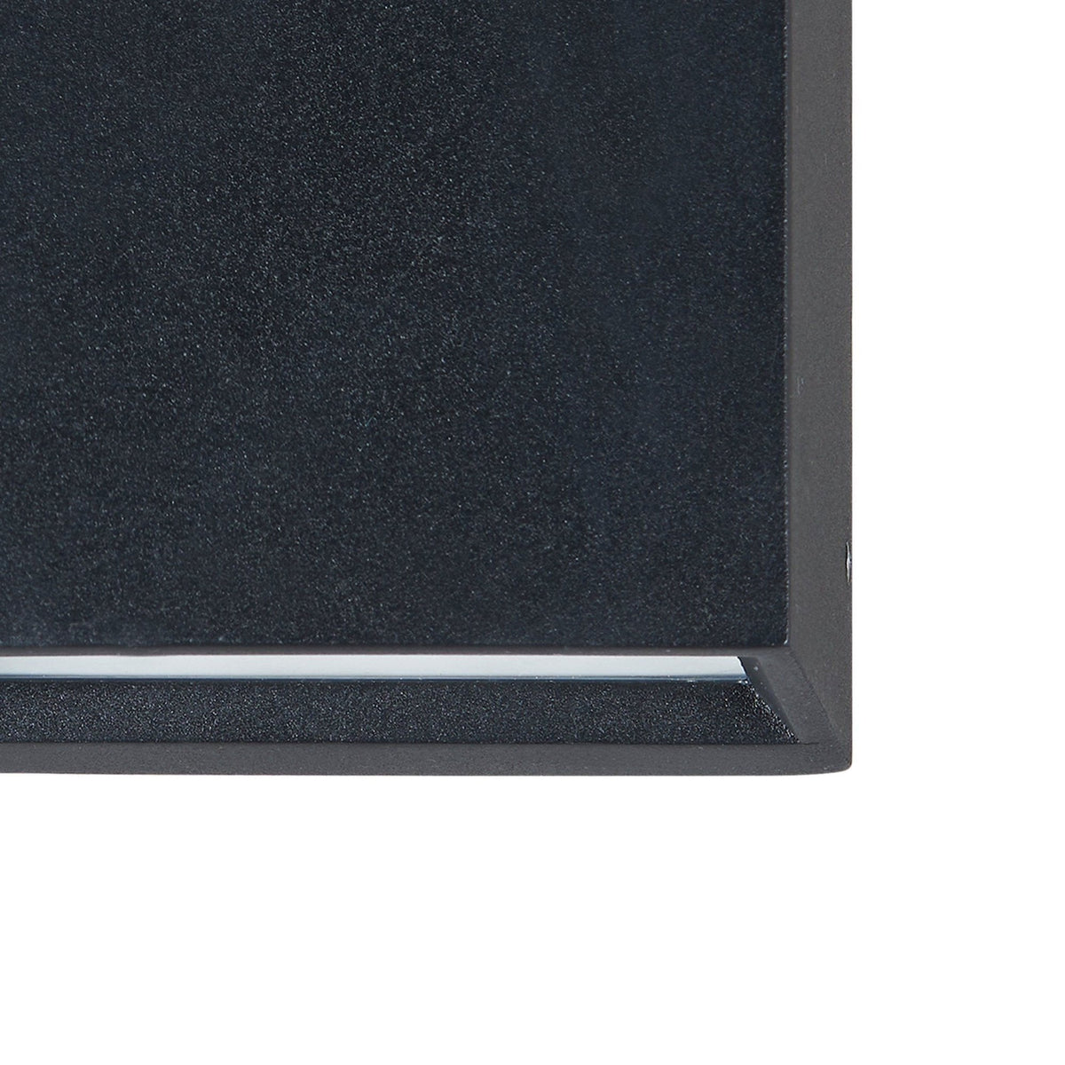 A close-up of the textured black finish on an outdoor wall light.