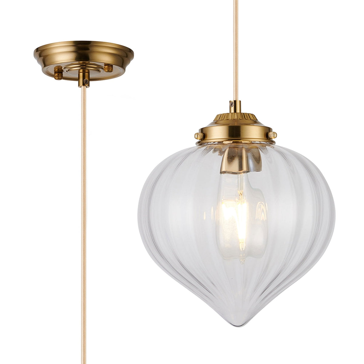 A close up of the pendant light with the brass base and the cable shown clearly.