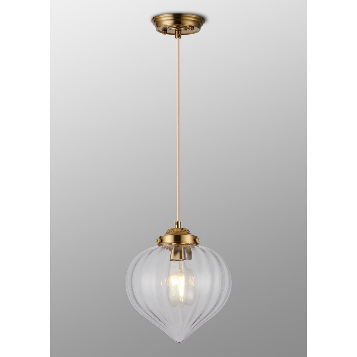 The pendant light, illuminated with a warm glow, against a neutral background.
