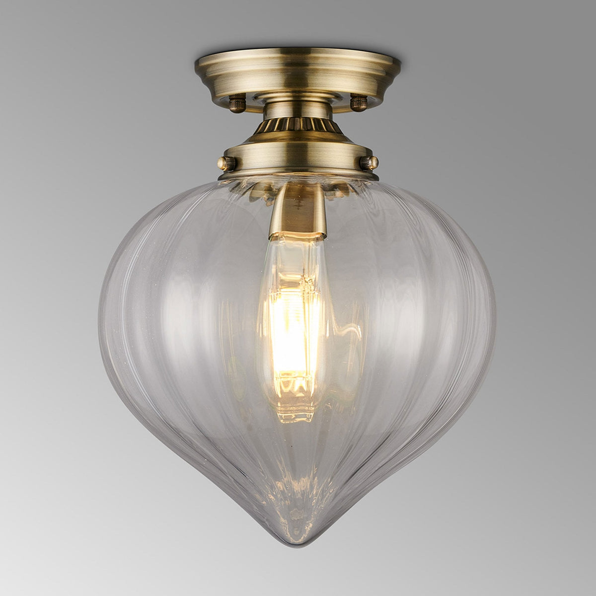 Appin Flush Ceiling Light in Antique Brass with Clear Flower Bud Glass Shade