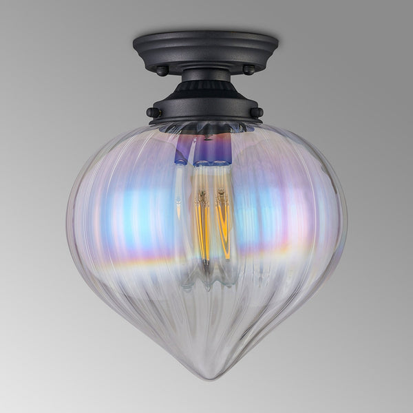 A close-up of a ceiling light featuring a clear, iridescent glass shade and a dark base.