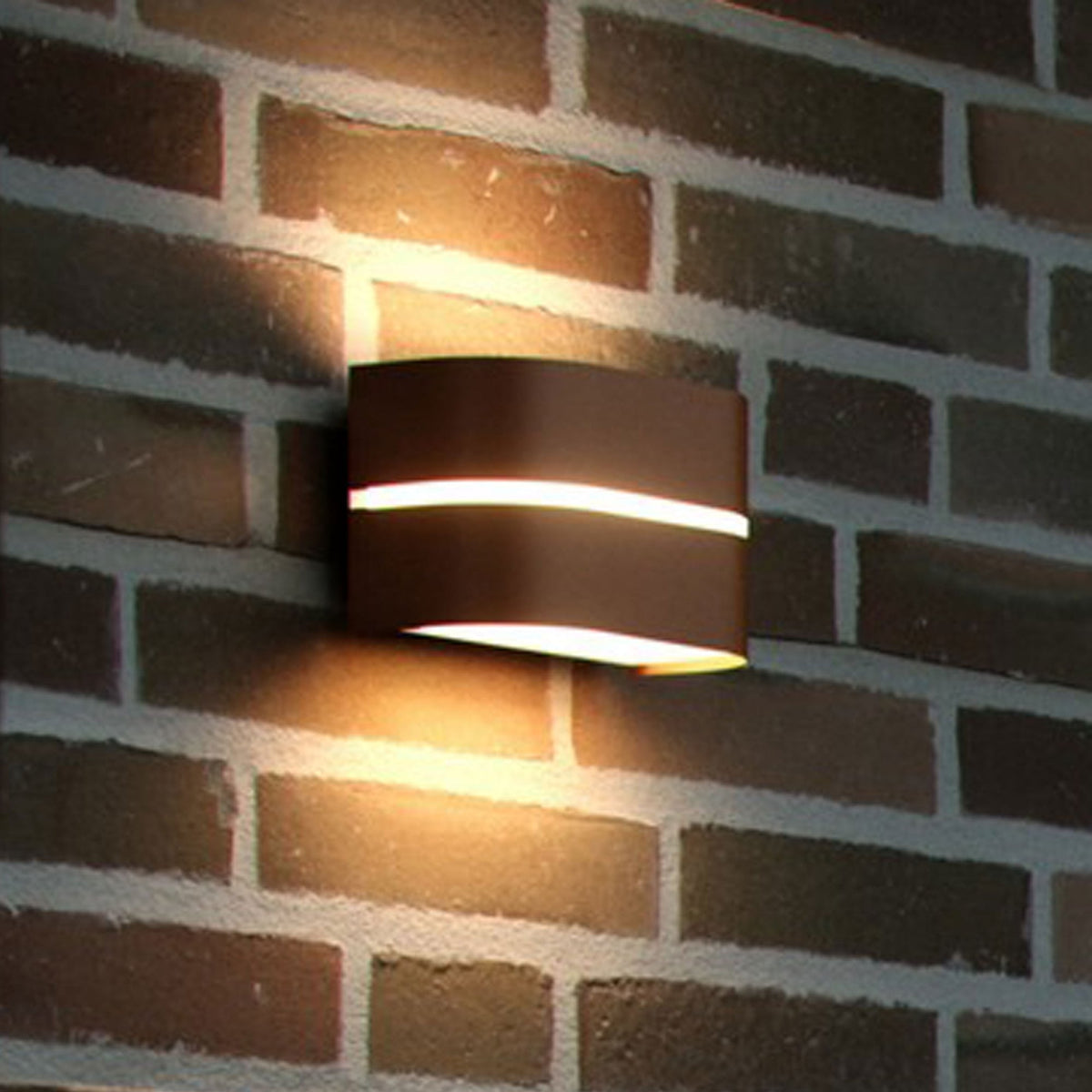 An oval-shaped, dark grey outdoor wall light with a horizontal glow in the middle.
