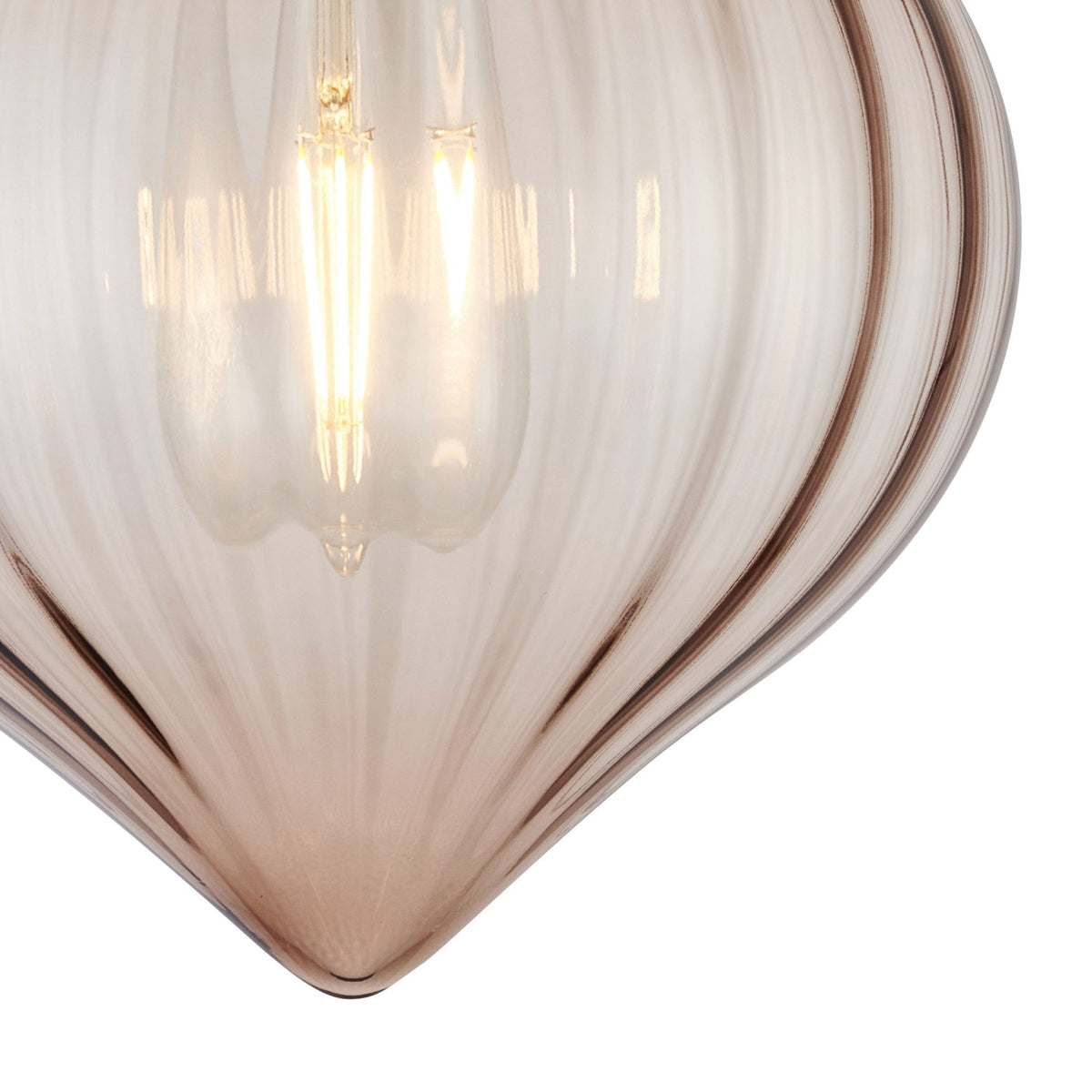 A close-up of the bottom of a clear fluted glass shade, revealing the light bulb inside.