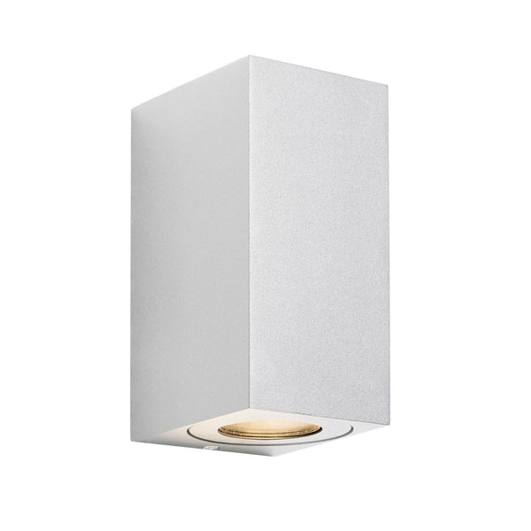 Close-up of a white rectangular outdoor wall light with a single downward-facing bulb.