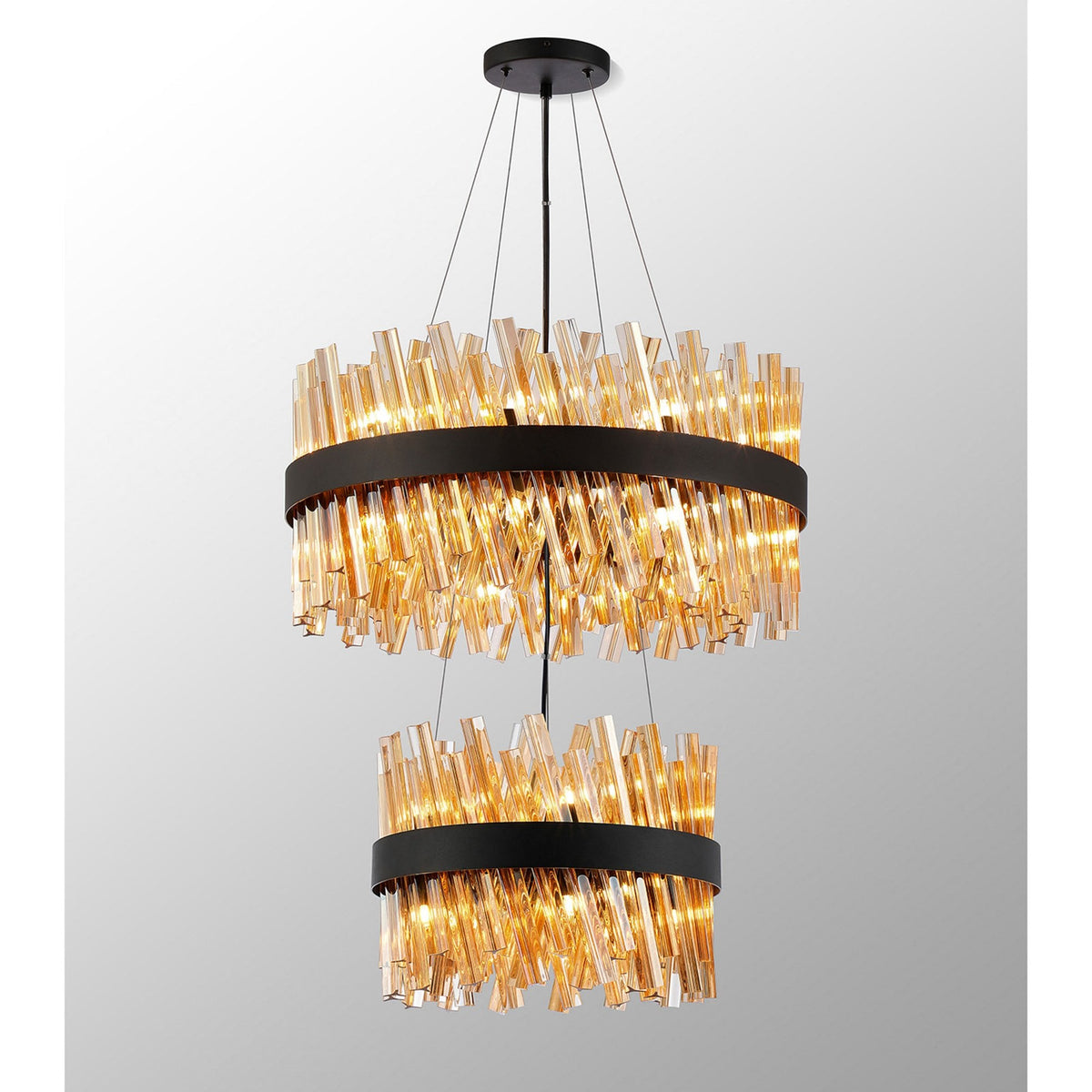 A modern two-tier chandelier with amber glass rods angled outwards around a black band.