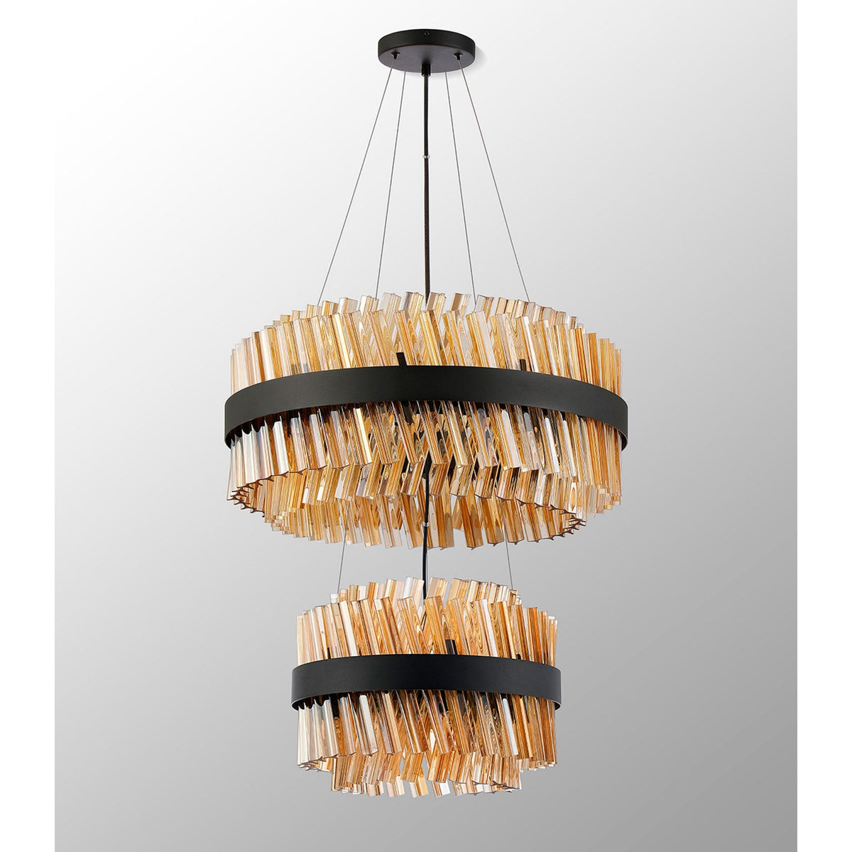 A modern two-tier chandelier with amber glass rods arranged horizontally around a black band.