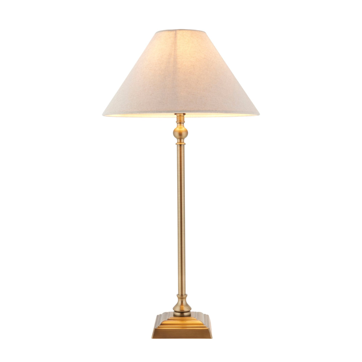 A tall brass table lamp with a conical light linen shade on a white background.