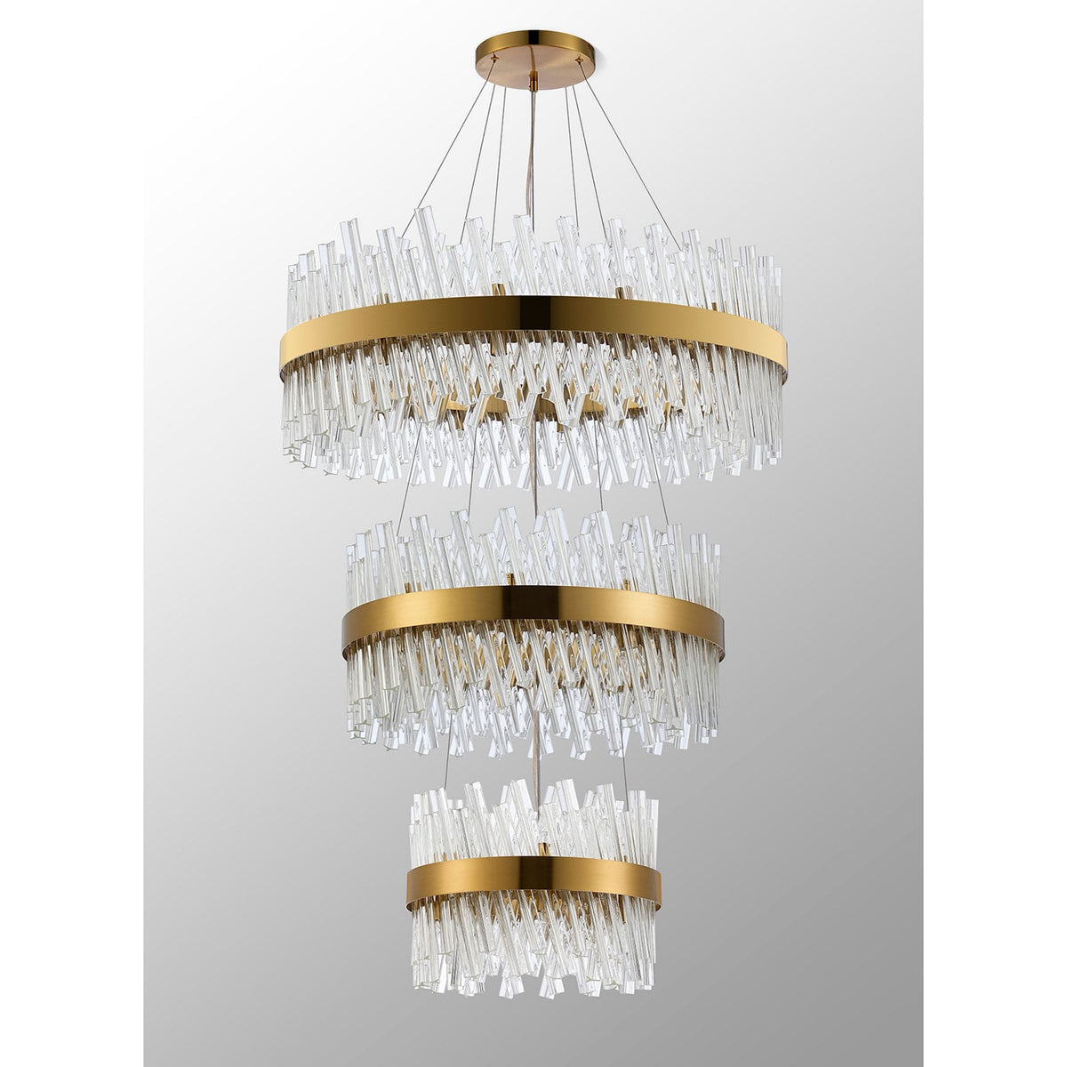A modern three-tier chandelier featuring gold bands and sparkling clear glass rod detailing.