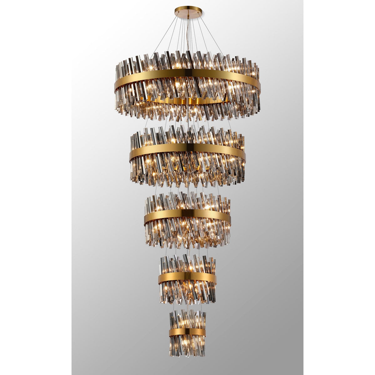 A luxurious tiered chandelier with golden bands and sparkling crystal rods, illuminated brightly.