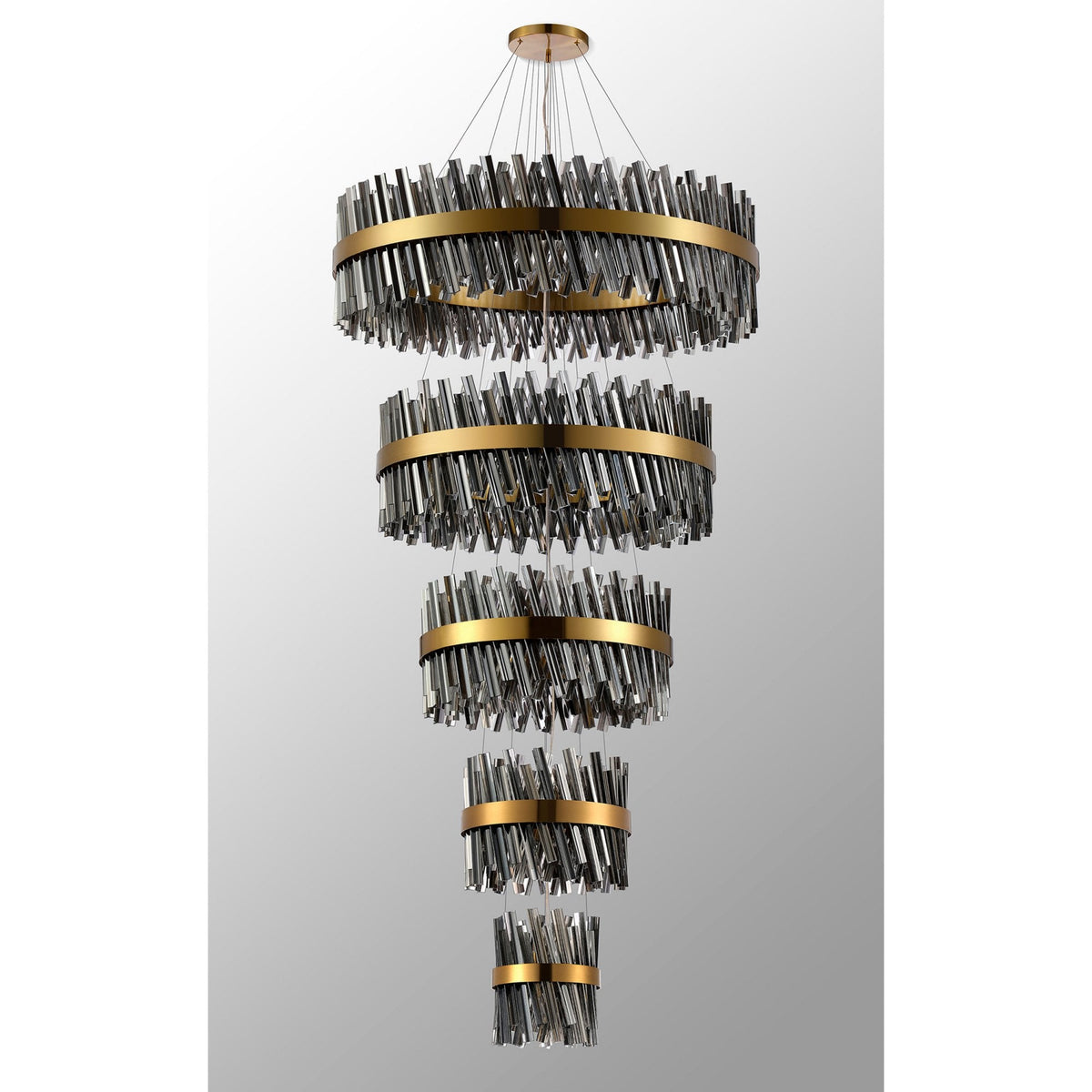 A luxurious tiered chandelier with golden bands and sparkling crystal rods, unlit.
