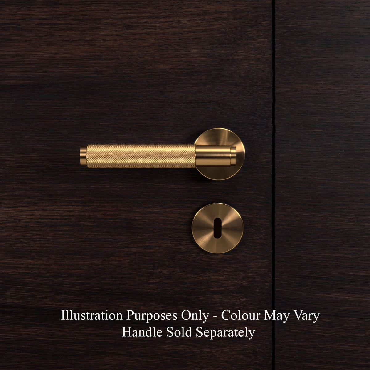 A brass door handle and keyhole cover on a dark wooden door.