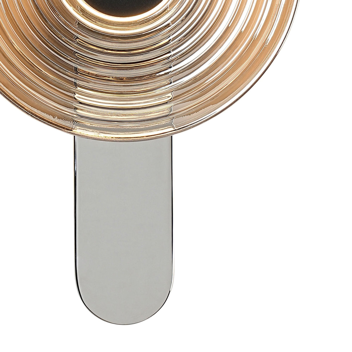 A close-up of the chrome base and lower section of the ridged, circular wall light.